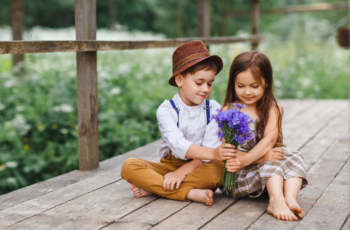 Мальчик любит сестру. Мальчик дарит девочке цветы. Любовь к ребенку. Дети пальчик и девочка.